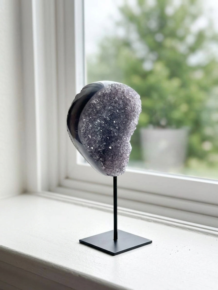 Dark amethyst druzy on windowsill lifestyle