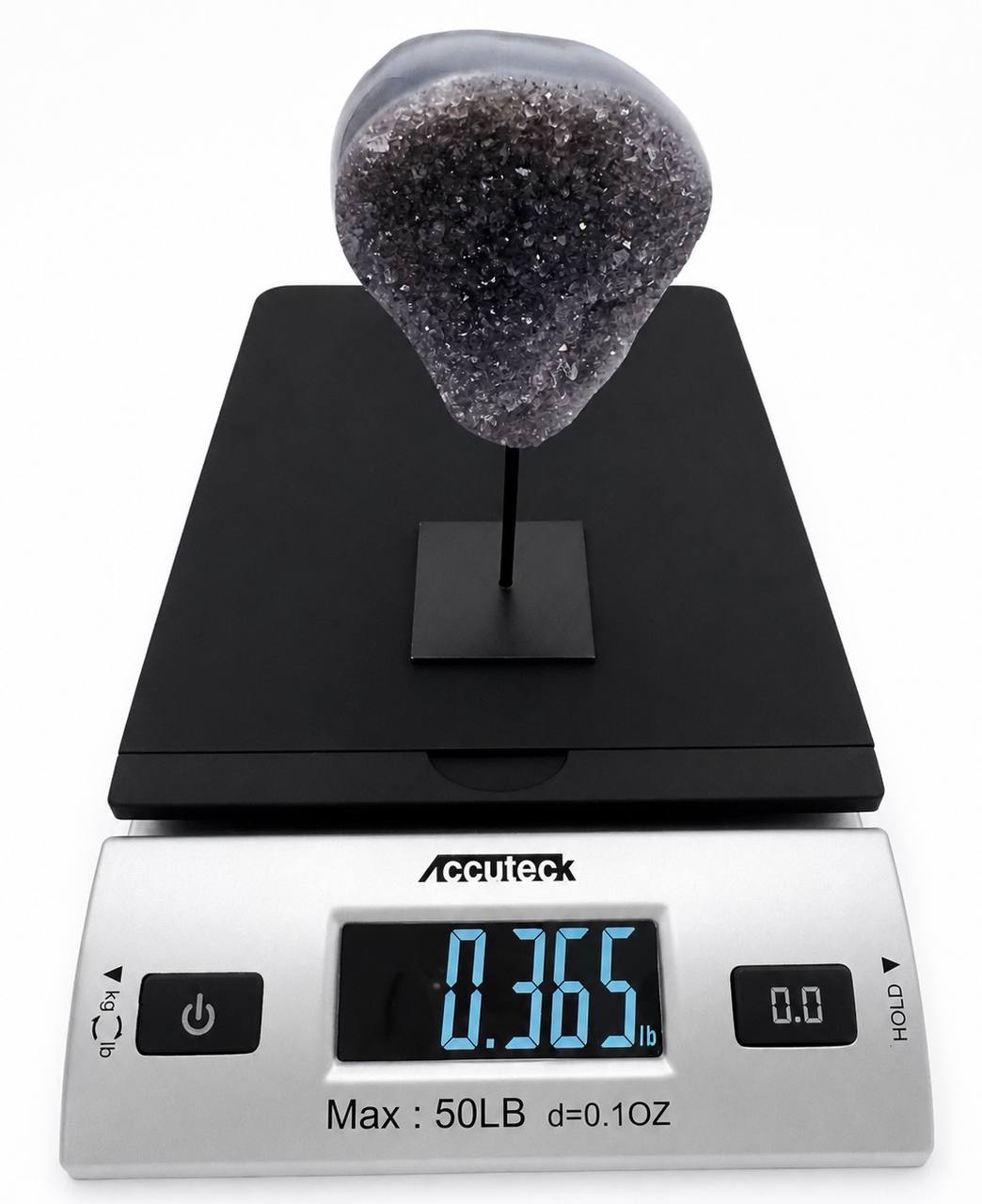 Dark amethyst druzy on scale reading 0.365 lbs