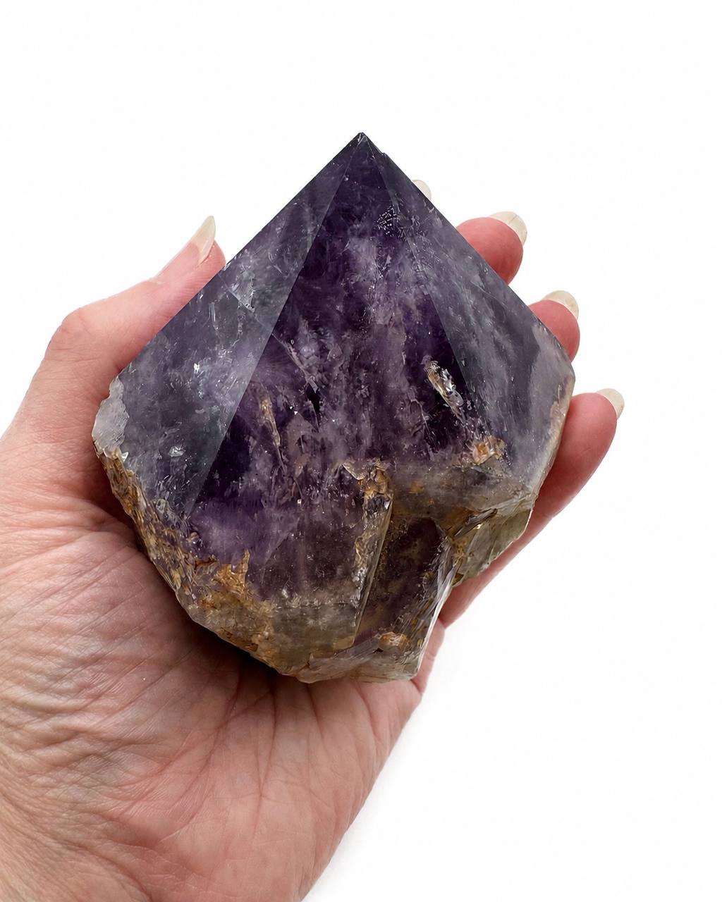 Amethyst chunk held in hand showing scale
