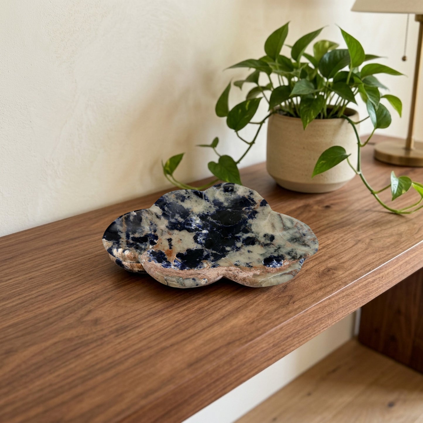 Sunset sodalite cloud dish on a walnut entry console with a pothos plant