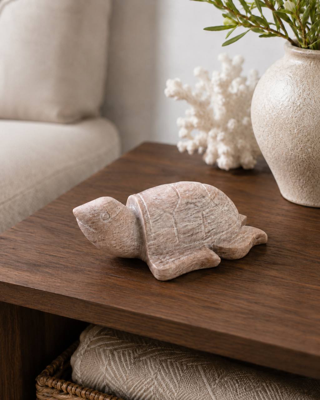 Peach moonstone turtle carving on wooden table