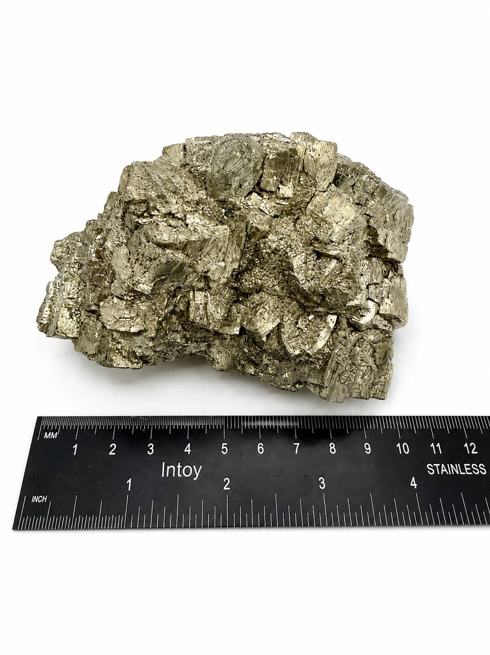 Pyrite cluster front view with ruler showing approximately 4 inches wide