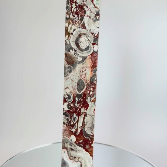 Money Agate Tower rotating on a mirrored turntable, showing all faces and orbicular eyes