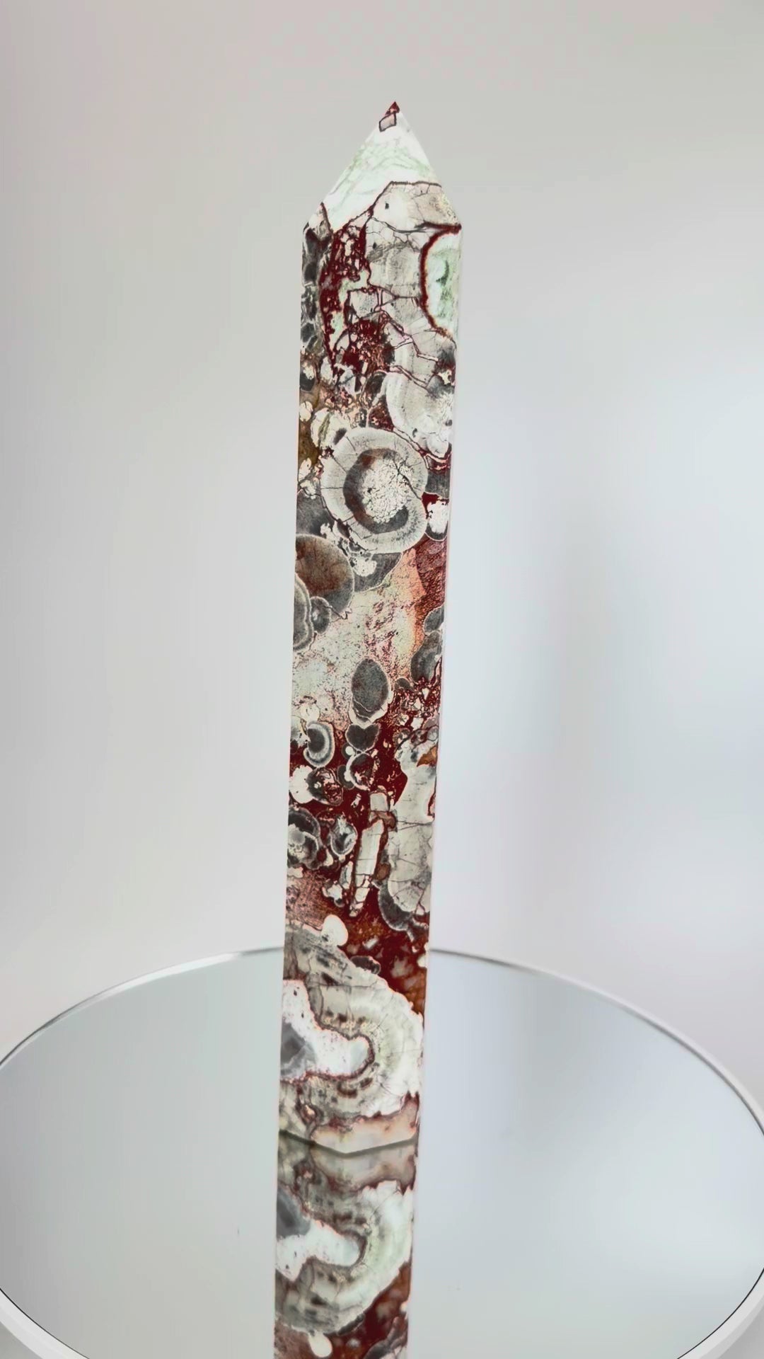 Money Agate Tower rotating on a mirrored turntable, showing all faces and orbicular eyes