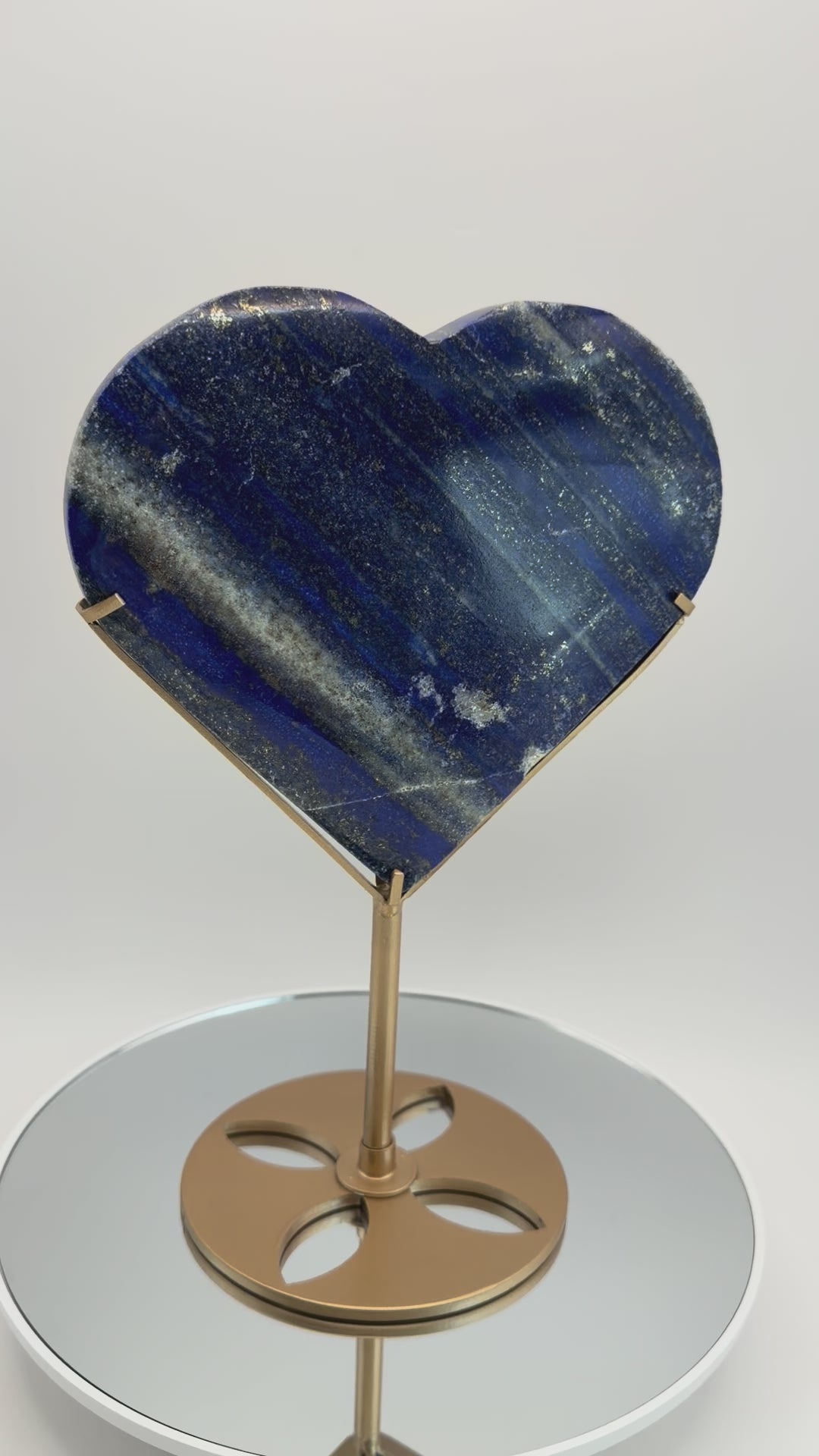 Lapis lazuli heart on gold stand, video