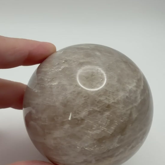 Peach moonstone sphere video showing shimmer and adularescence