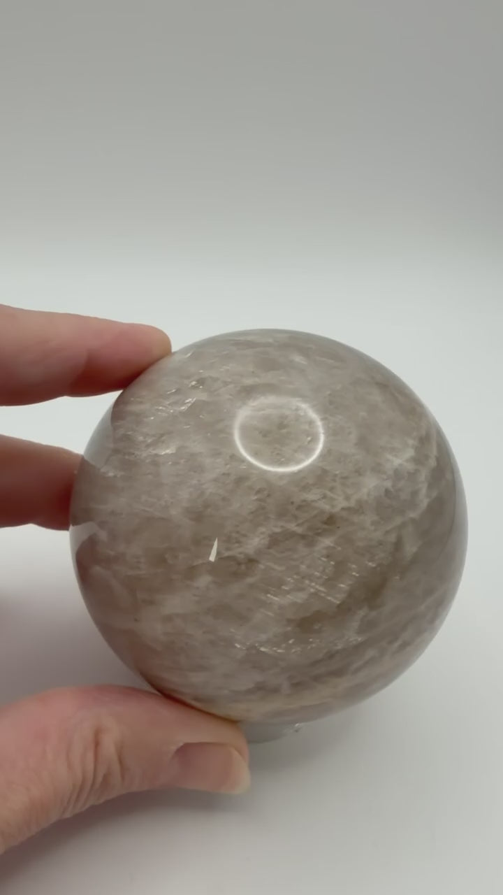 Peach moonstone sphere video showing shimmer and adularescence