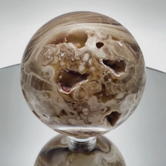 Chocolate calcite sphere video showing banding from all angles