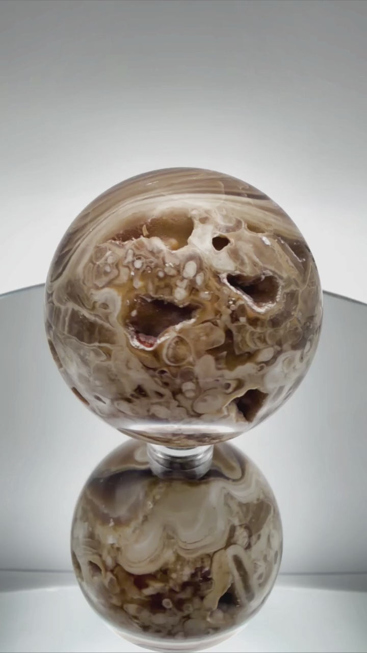 Chocolate calcite sphere video showing banding from all angles