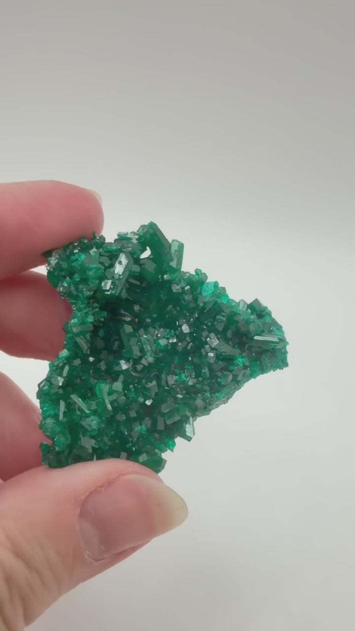 Dioptase crystal cluster video showing emerald green crystal coverage