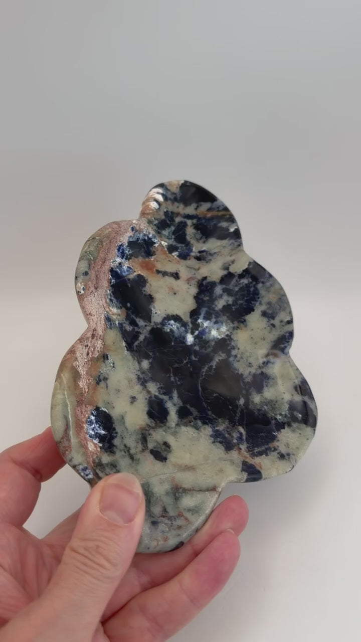 Turning the sunset sodalite cloud dish in hand