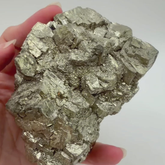 Pyrite crystal cluster video showing metallic luster from multiple angles