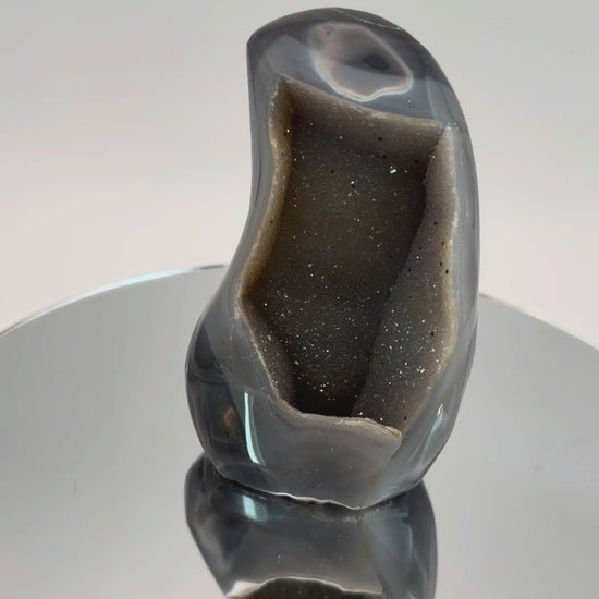 Banded agate geode with druzy quartz cave