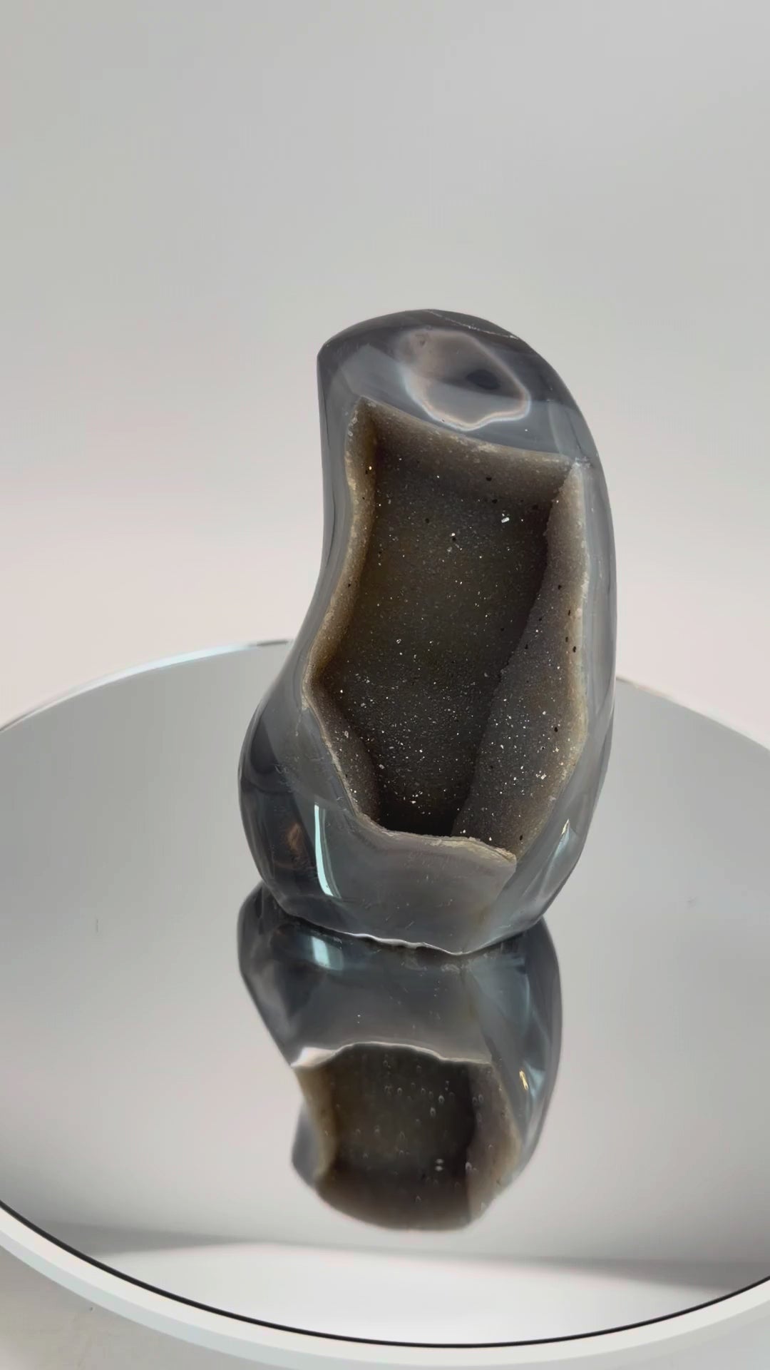 Banded agate geode with druzy quartz cave