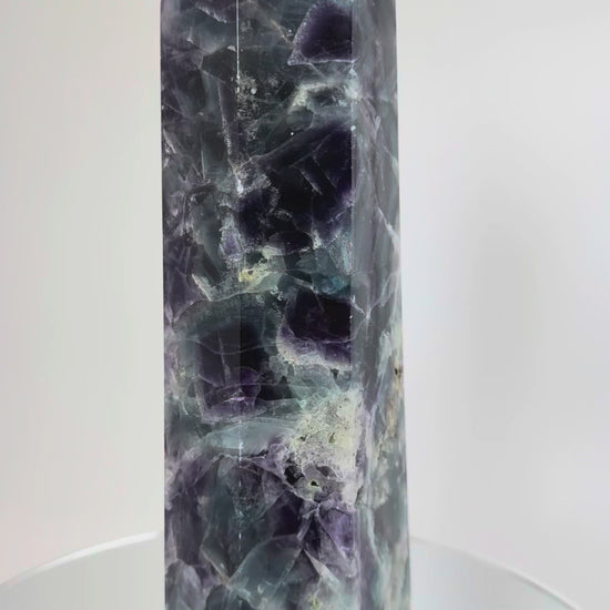 Rainbow fluorite tower rotating, showing internal cleavage planes
