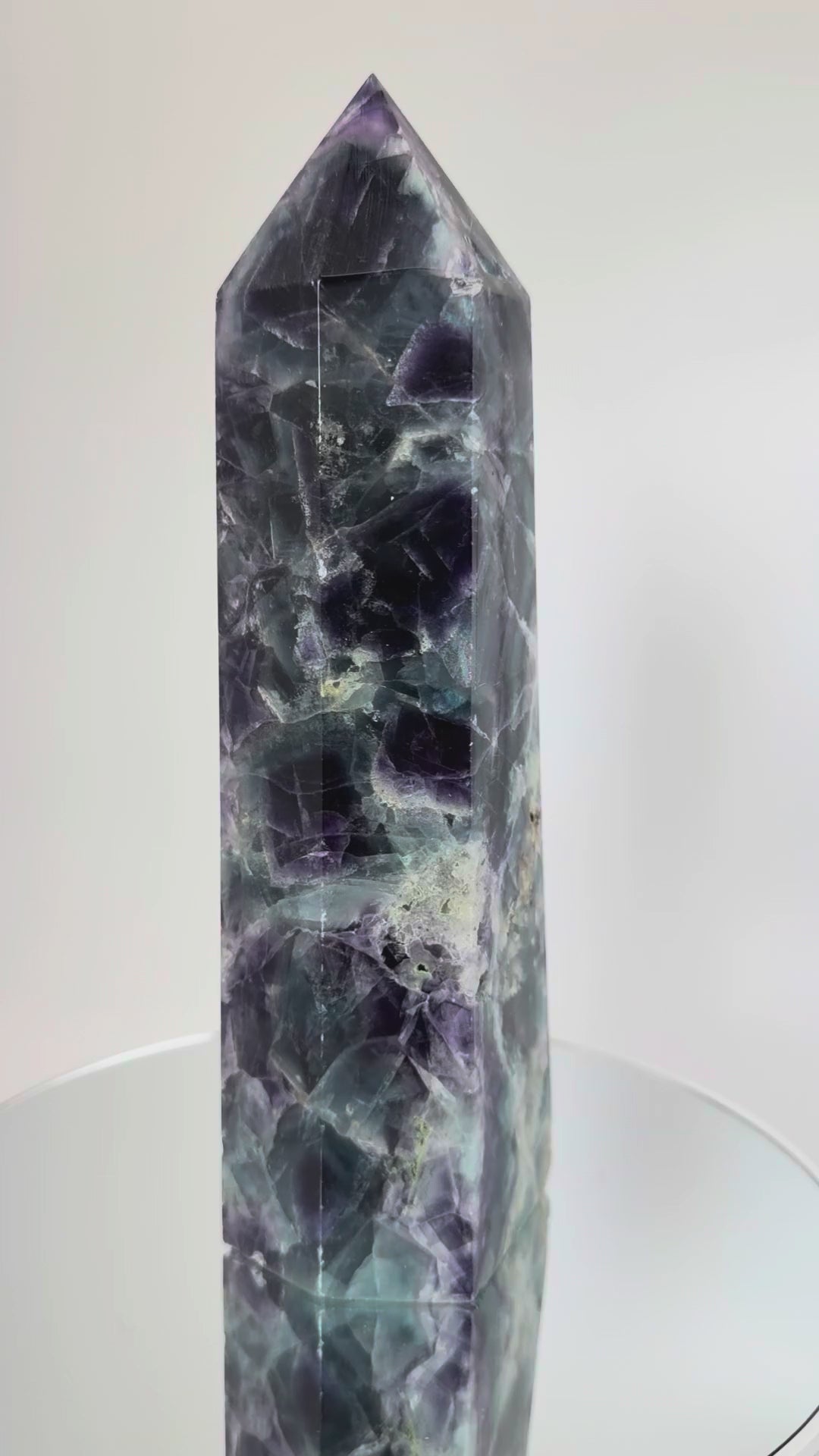 Rainbow fluorite tower rotating, showing internal cleavage planes