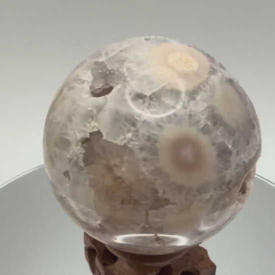 Flower agate sphere turning in the light