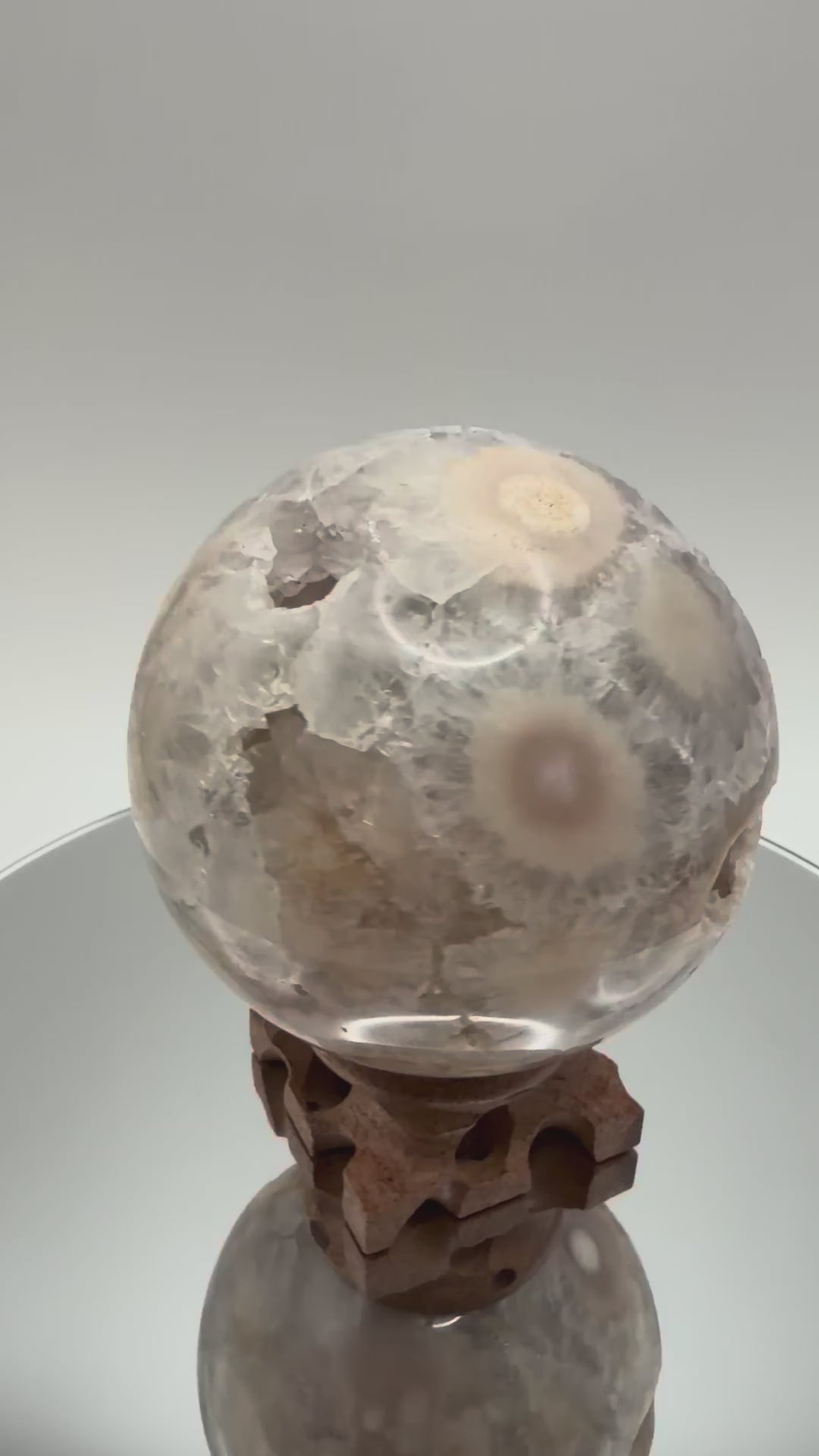Flower agate sphere turning in the light