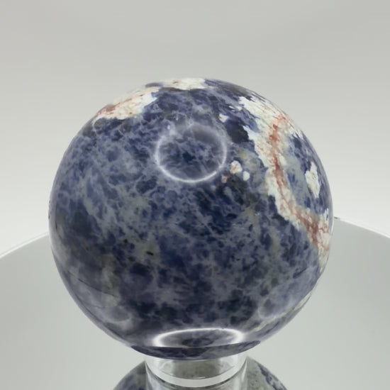 Sunset Sodalite sphere turning in the light