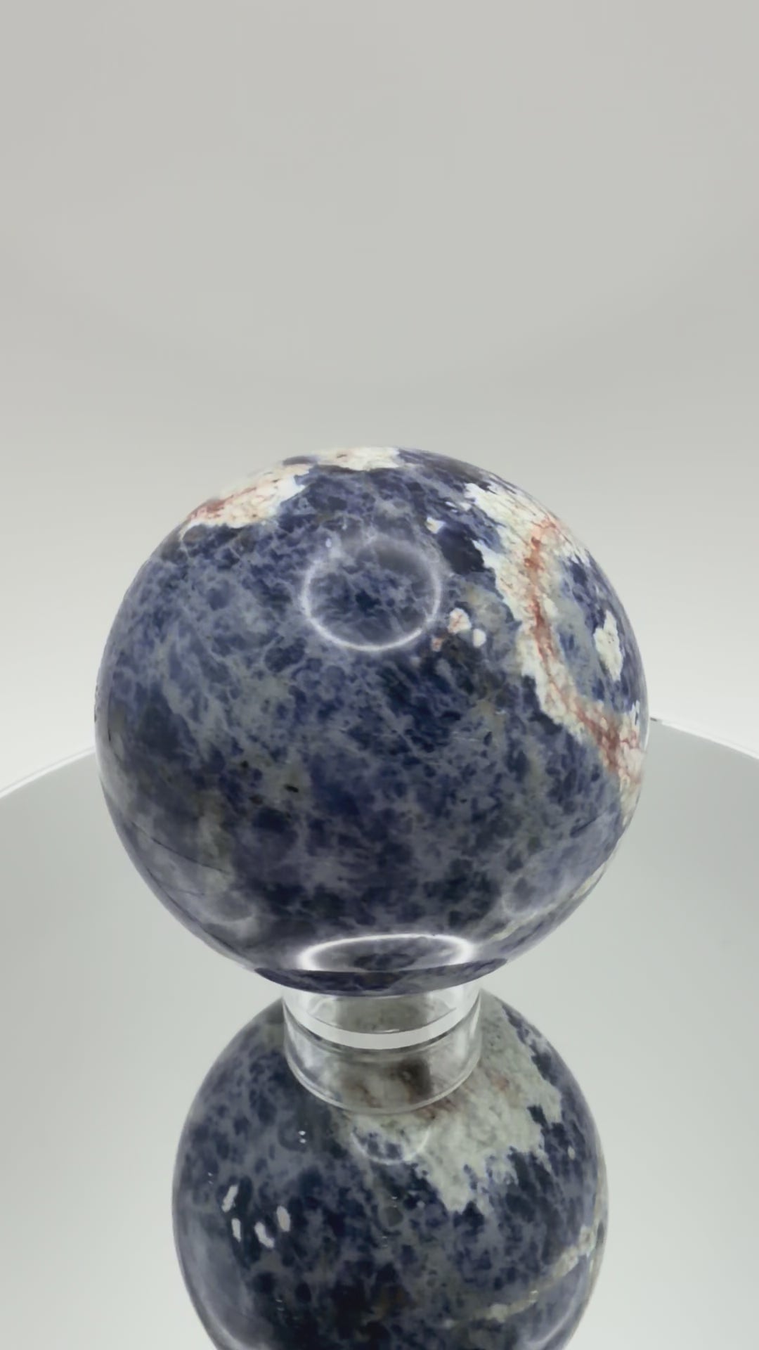 Sunset Sodalite sphere turning in the light