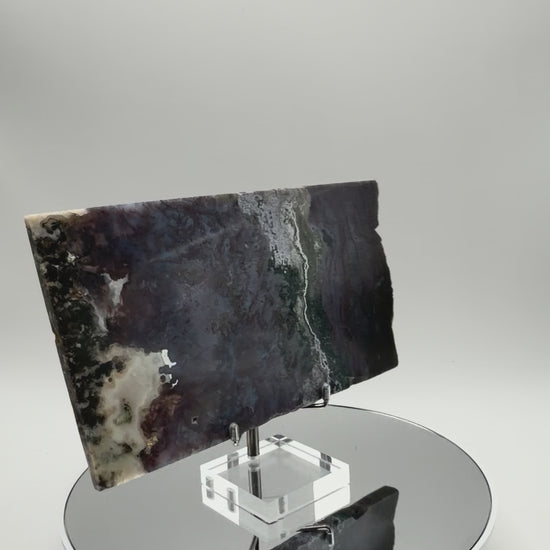 Purple moss agate slab turning in the light