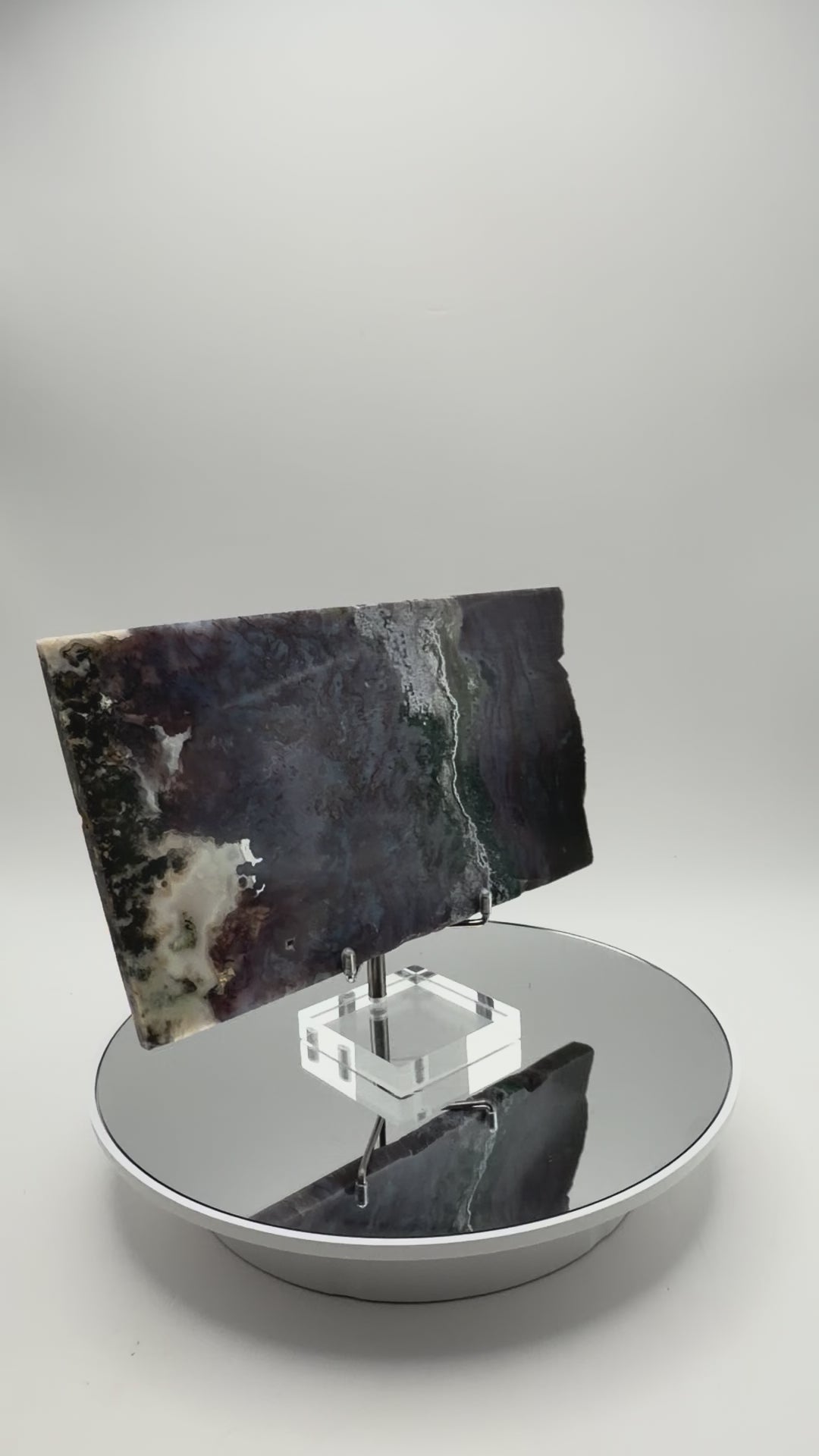 Purple moss agate slab turning in the light