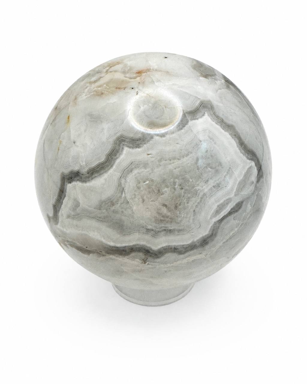 Grey banded onyx sphere showing amber accents