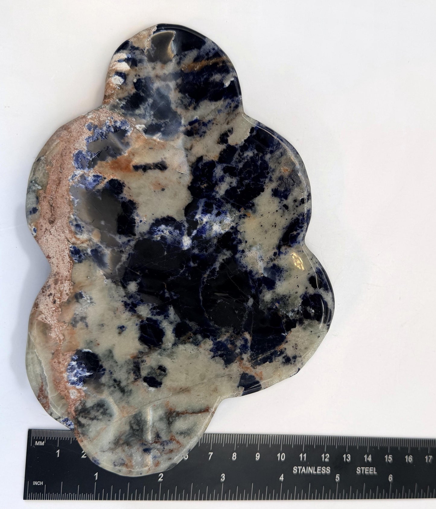 Sodalite cloud dish upright beside a steel ruler