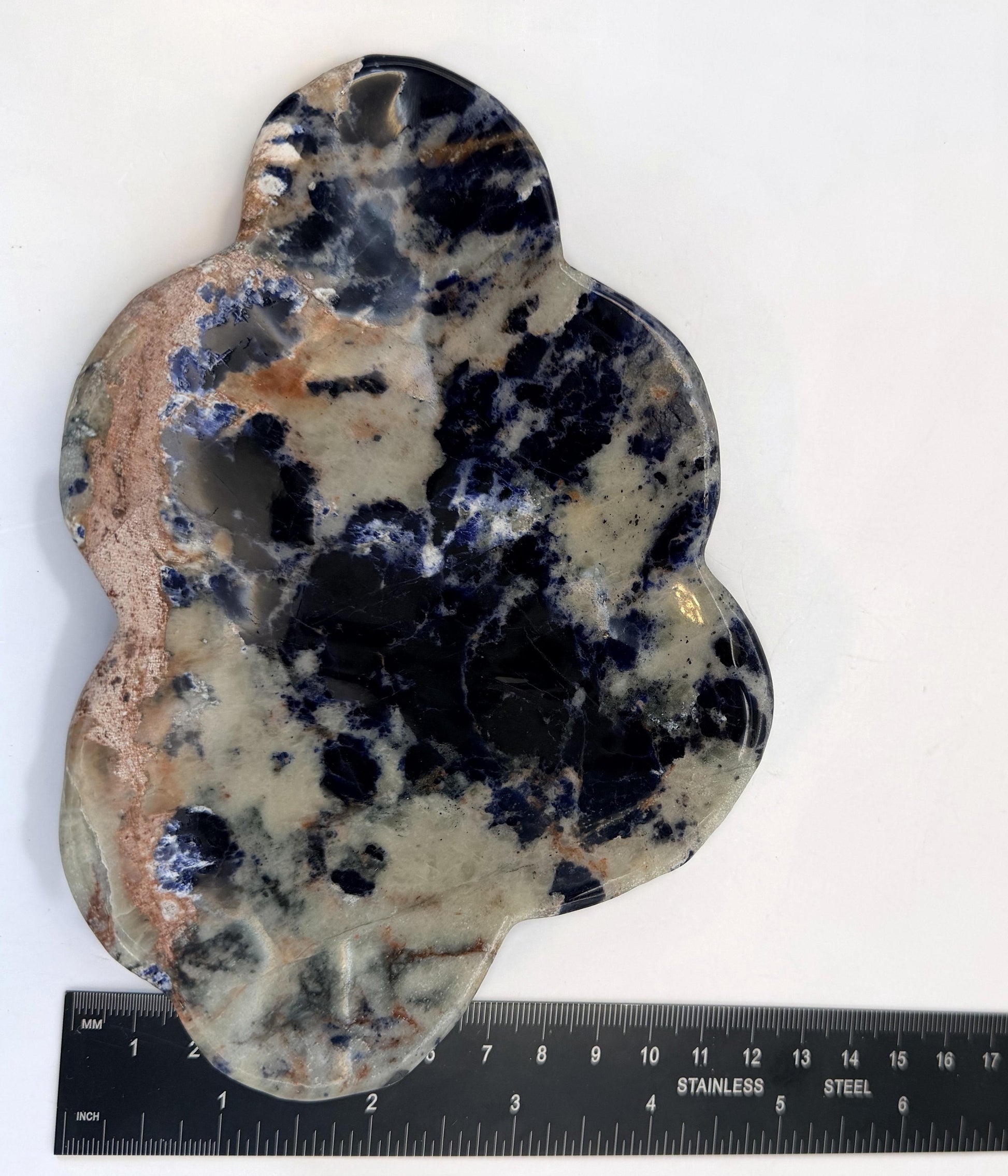 Sodalite cloud dish upright beside a steel ruler