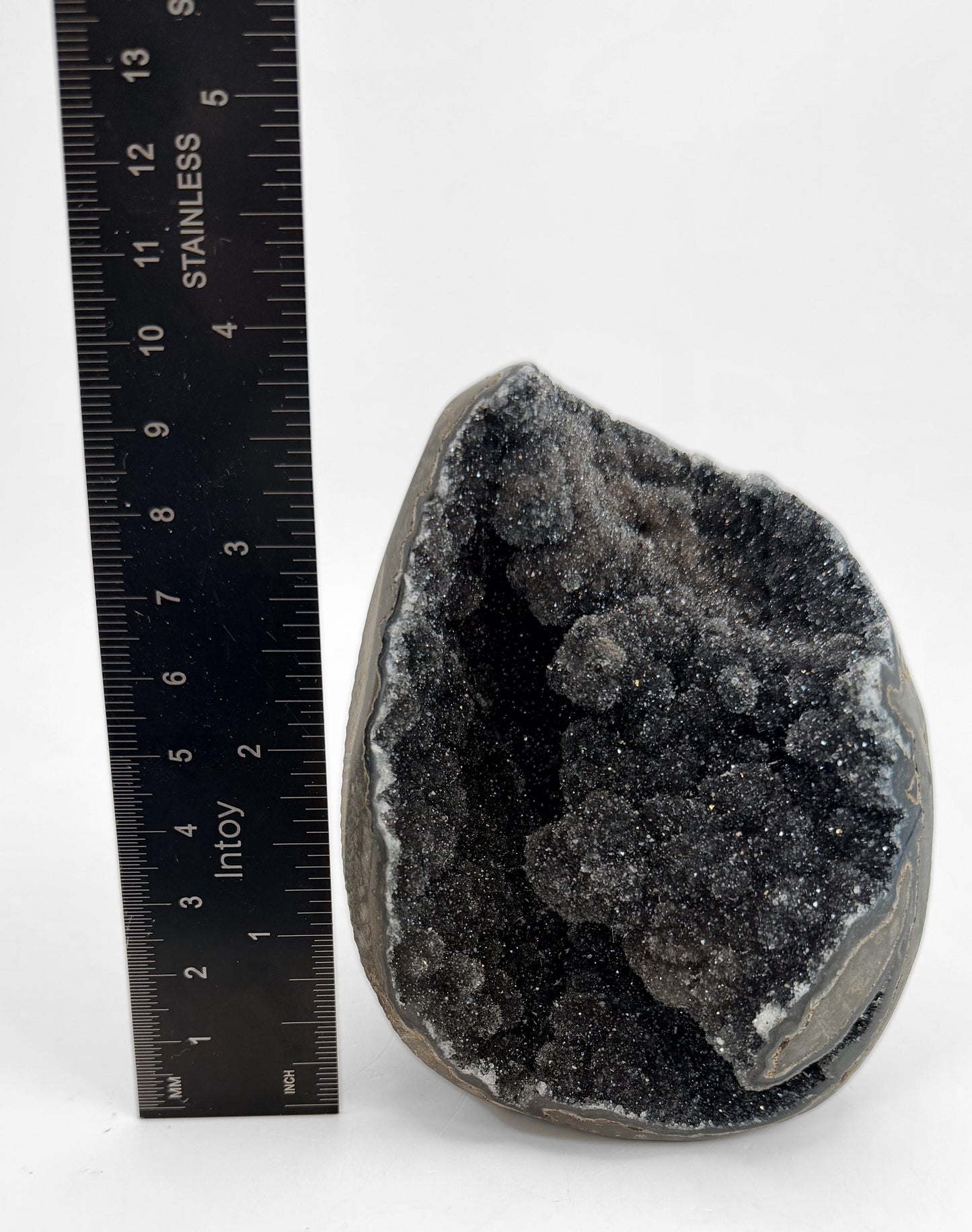 Druzy geode beside a steel ruler, about 4 inches tall