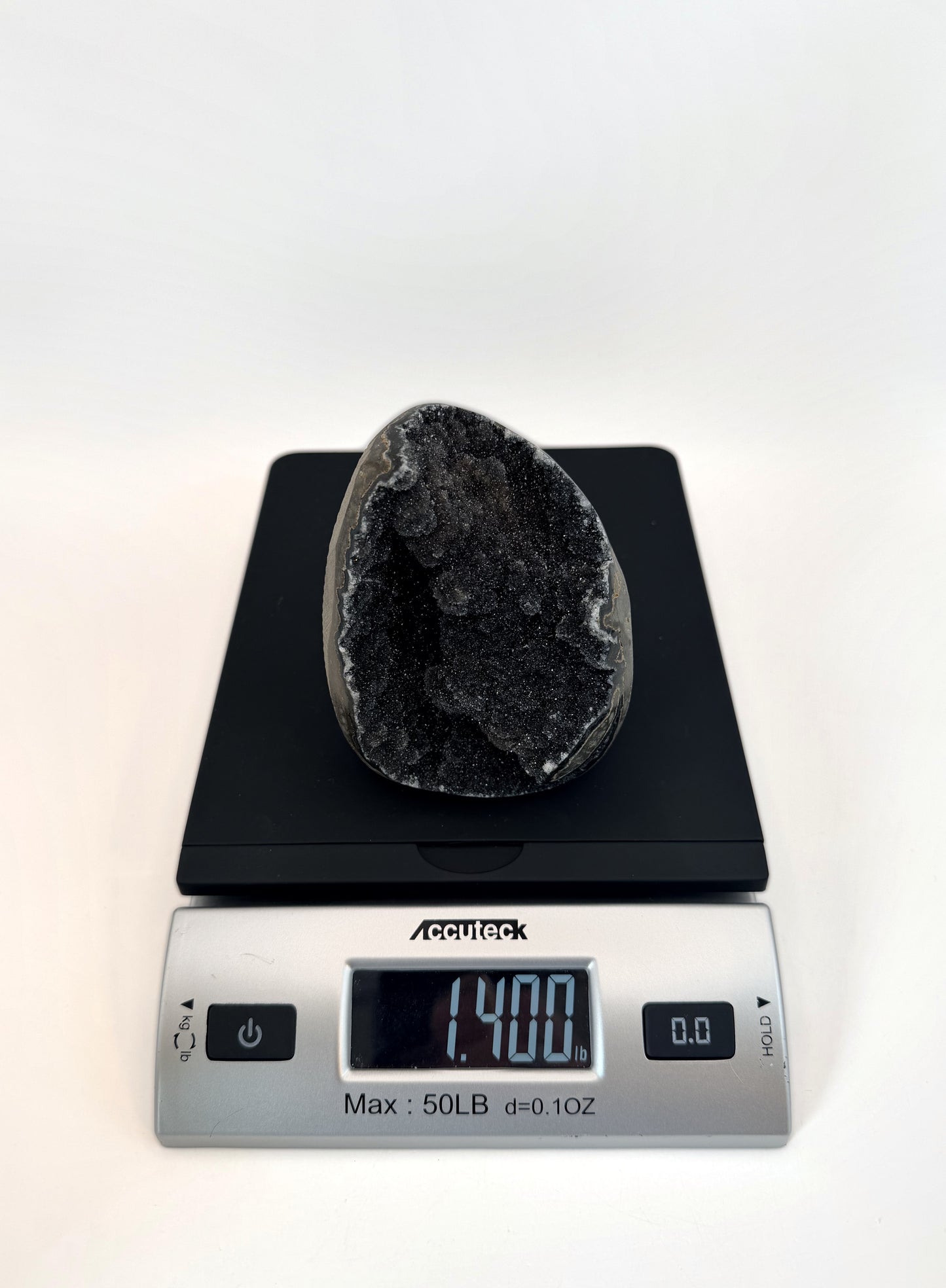 Black druzy quartz geode on the scale, 1.4 lb