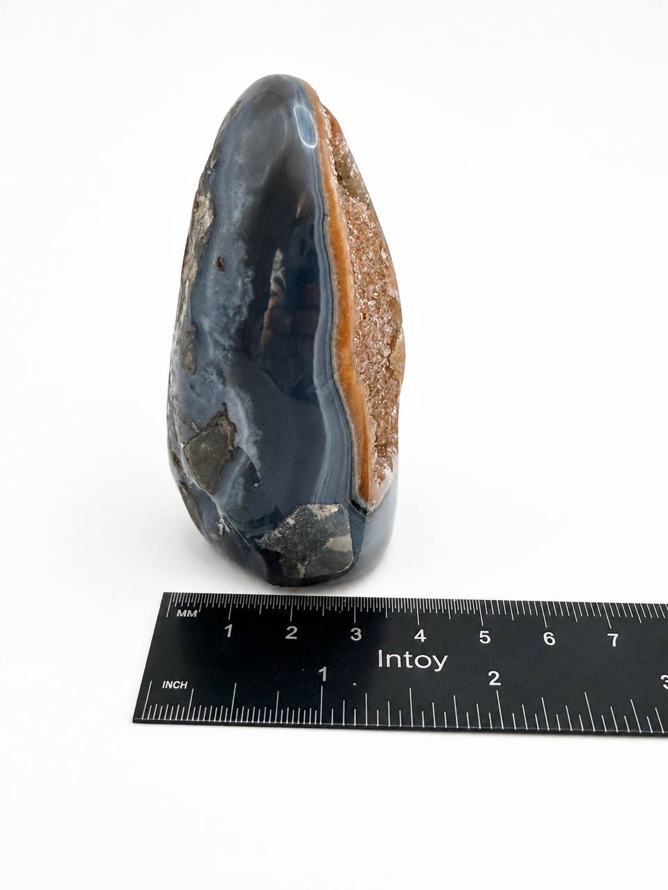 Polished agate freeform side view showing blue-grey banding and druzy edge
