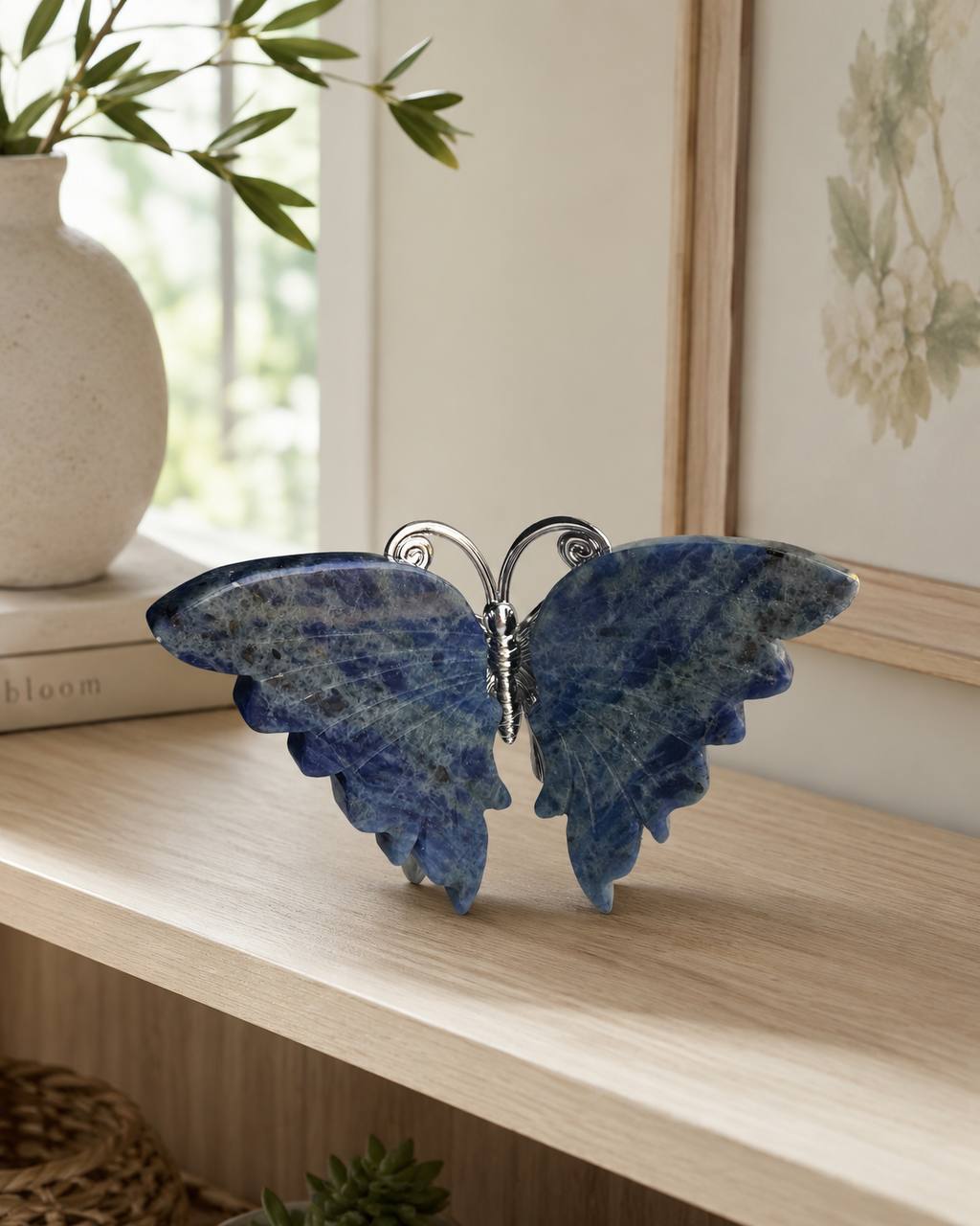 Sodalite crystal butterfly carving on wooden shelf