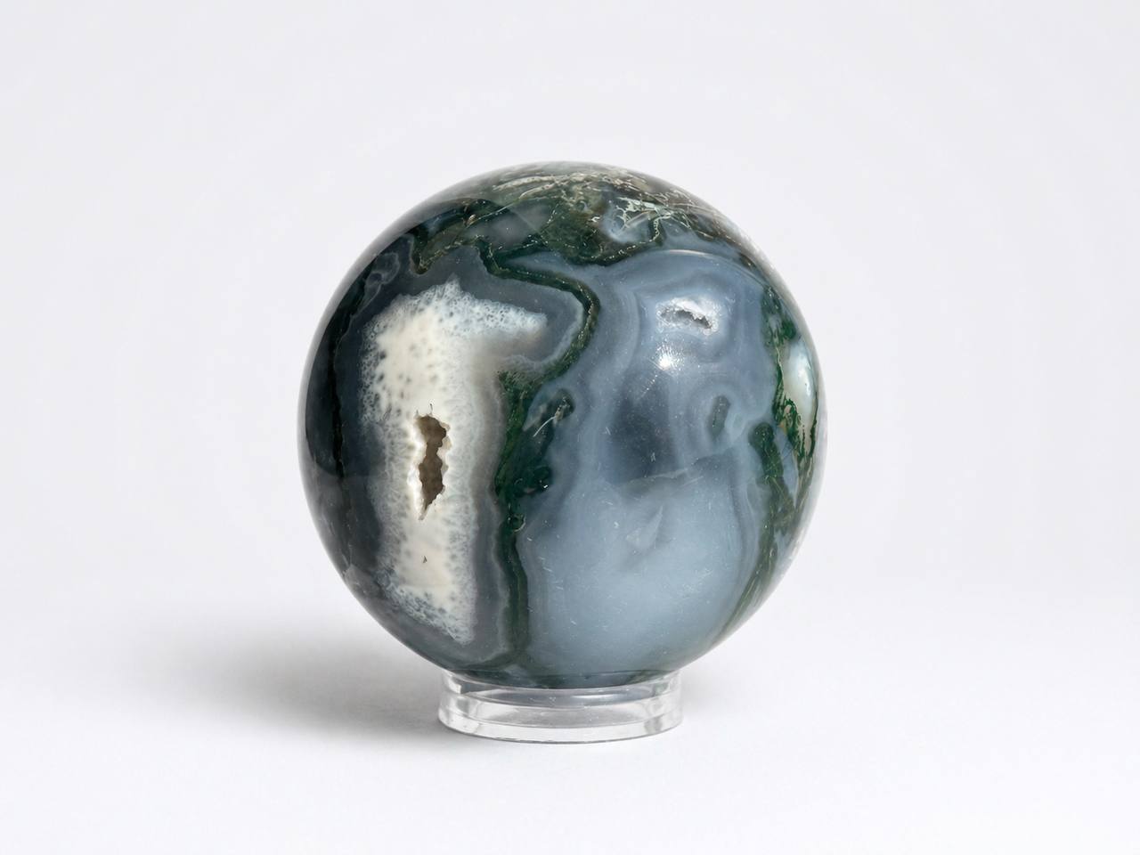 Moss agate sphere showing sparkling druzy quartz cavity