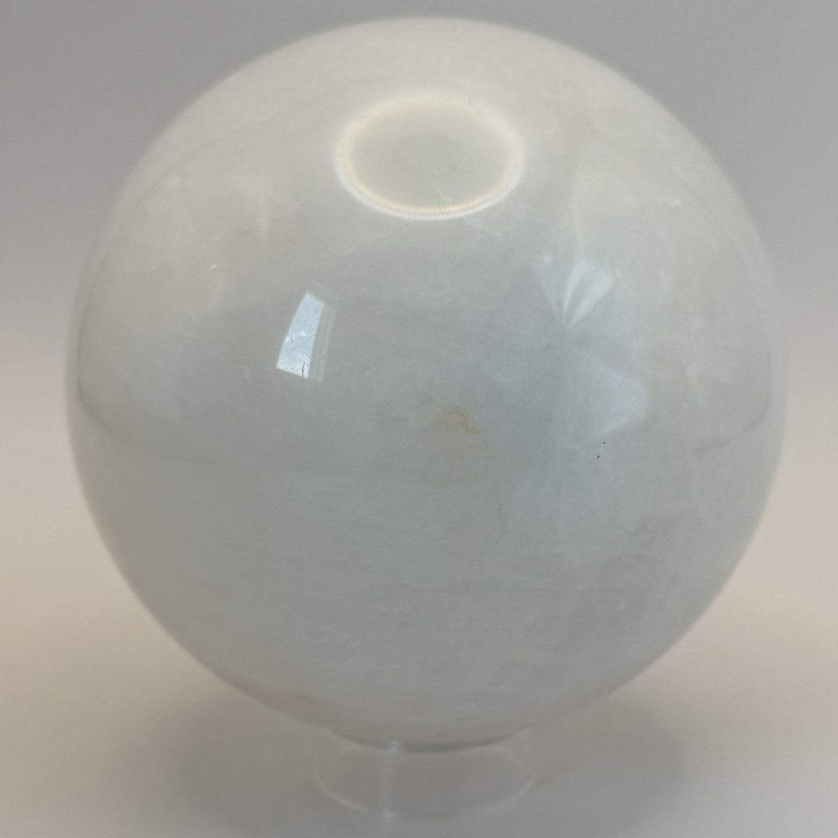 Milky quartz sphere on its clear ring stand