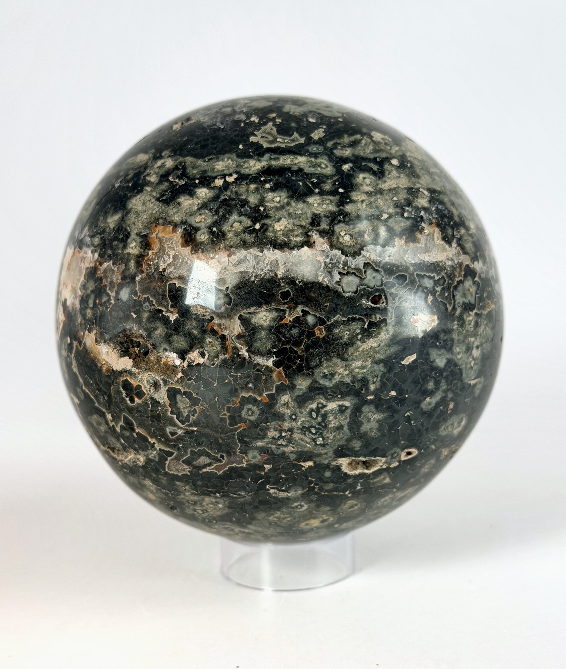 Ocean jasper sphere on its clear ring stand