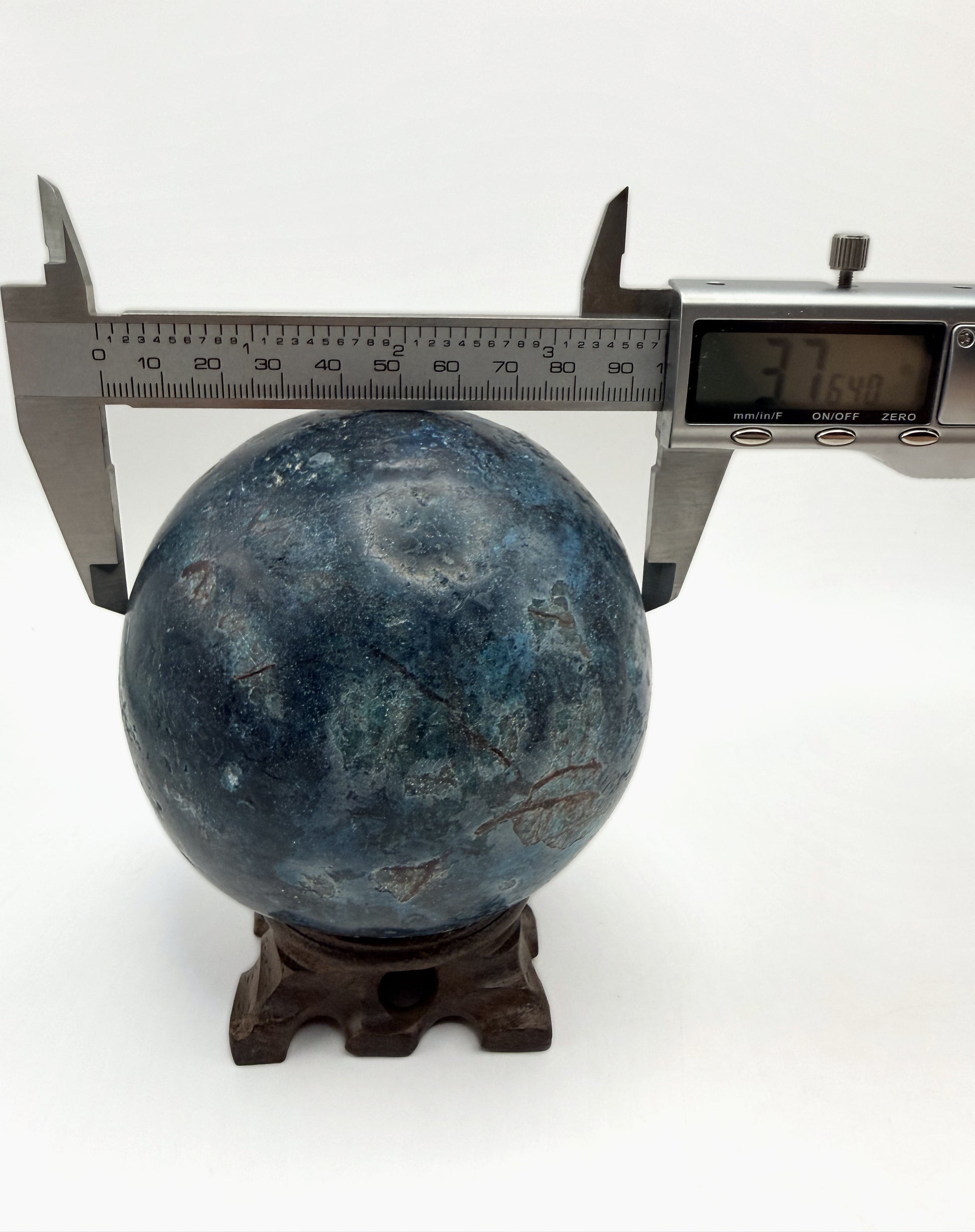 Blue apatite sphere measured with calipers