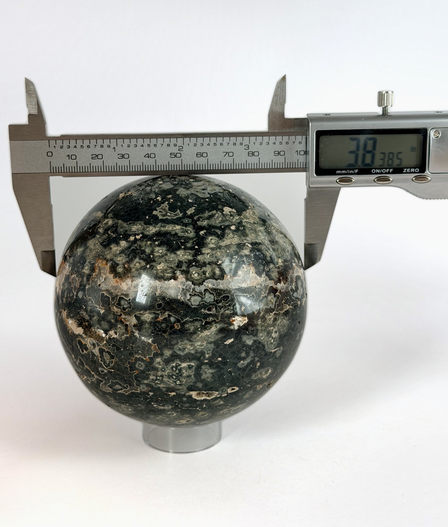 Ocean jasper sphere measured with calipers