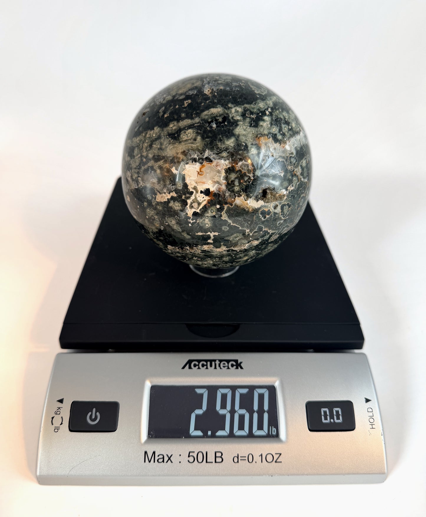 Ocean jasper sphere on a scale