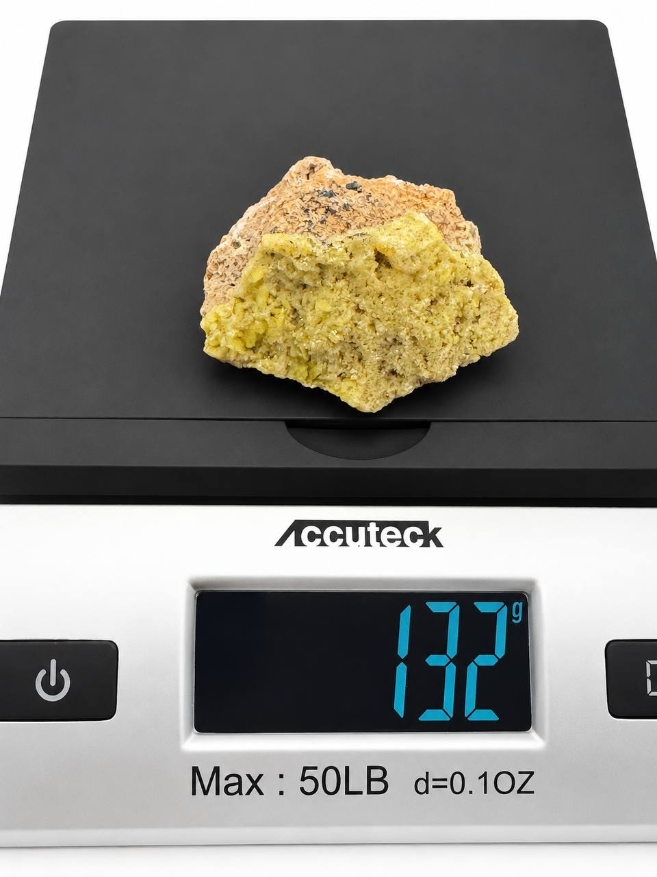 Mimetite specimen on scale showing 132 grams