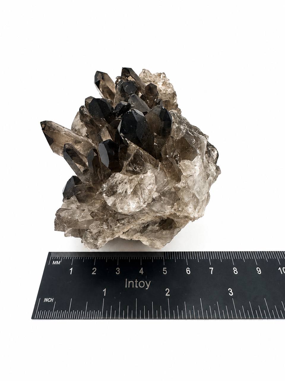 Smoky quartz cluster on scale showing 15.2 oz