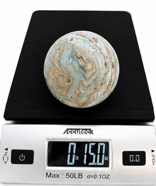 Caribbean calcite sphere on scale showing 15 oz