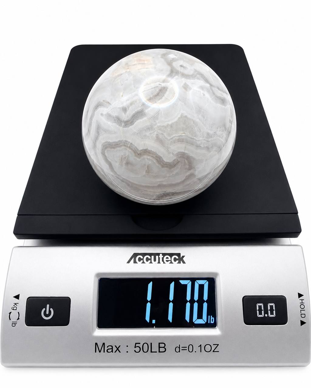 Grey banded onyx sphere on scale showing 1.17 lbs